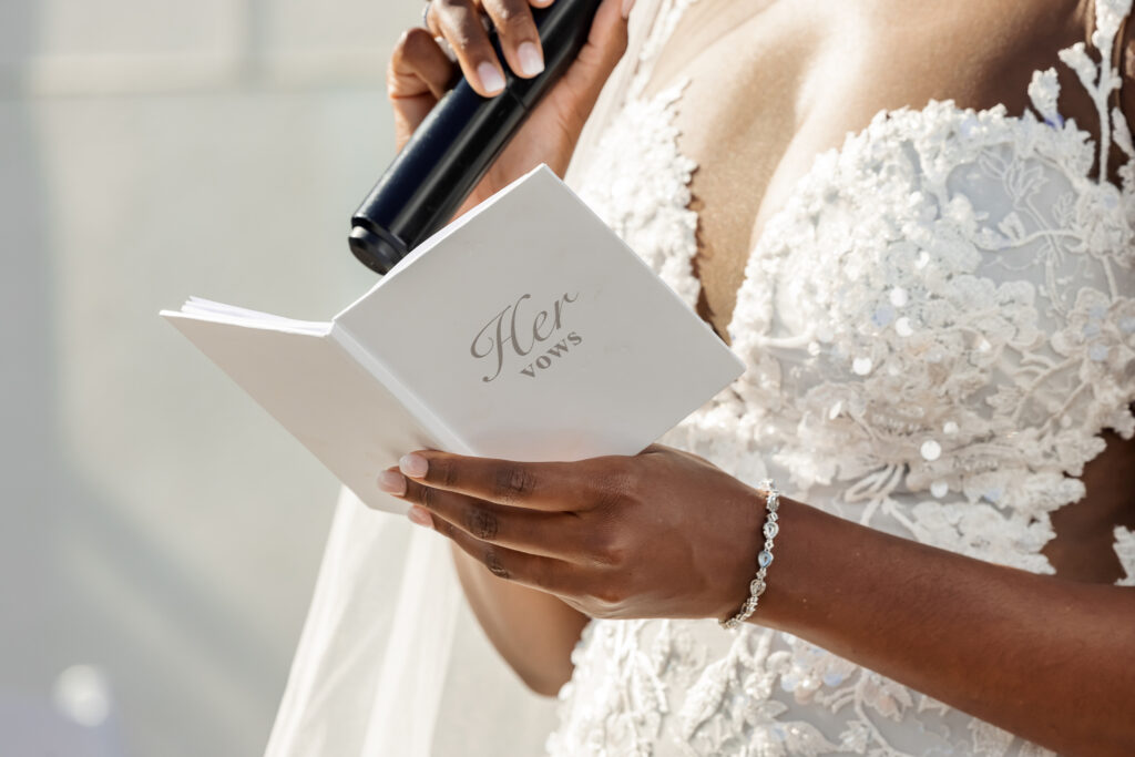 A bride at The Gramercy Lakeside Manor reading her vows